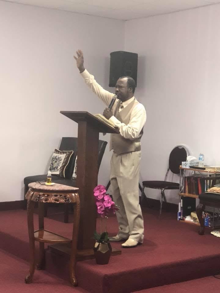 Bishop Wallace leading worship from the pulpit