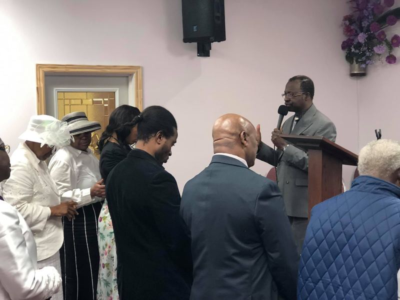 Members praying together at the front of the church
