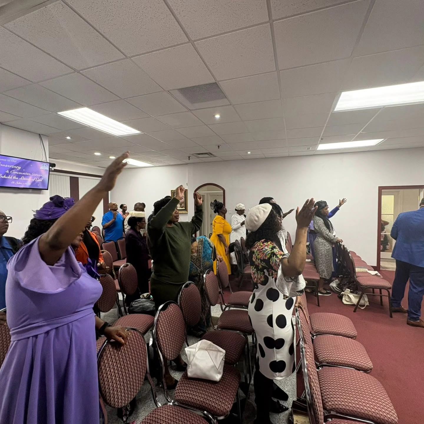 The congregation lifting their hands in worship at Gospel Light